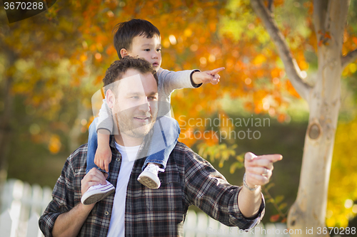 Image of Mixed Race Boy Riding Piggyback on Shoulders of Caucasian Father