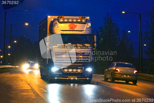 Image of Nighttime DAF XF Flower Truck and City Lights