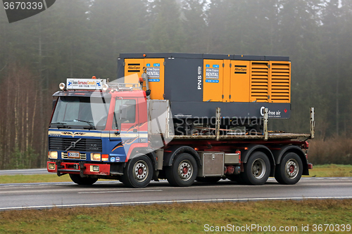 Image of Retro Volvo FL10 320 Truck Hauls a Compressor