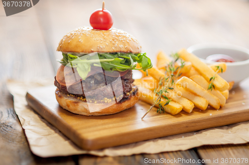 Image of Home made burgers on wooden background