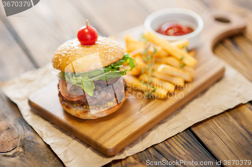 Image of Home made burgers on wooden background