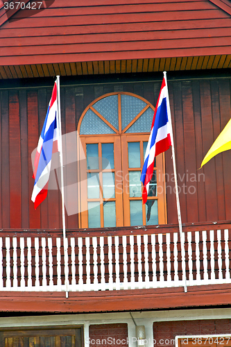 Image of temple   in  bangkok thailand incision red  waving flag 