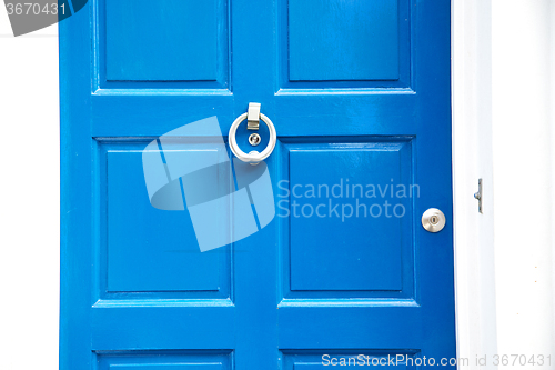 Image of  blue handle in   rusty  brass nail  