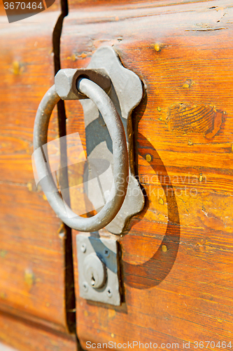 Image of europe   in  italy    brown door and rusty lock  closeup