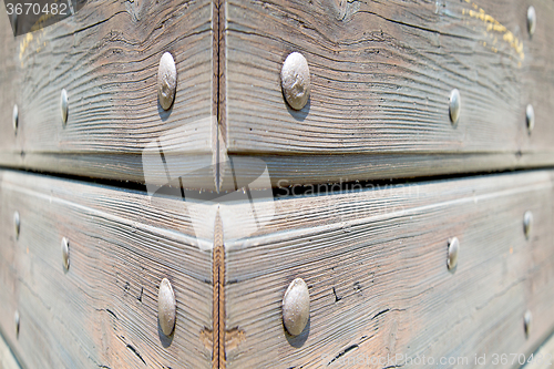 Image of abstract texture of a brown antique wooden old door in italy   e