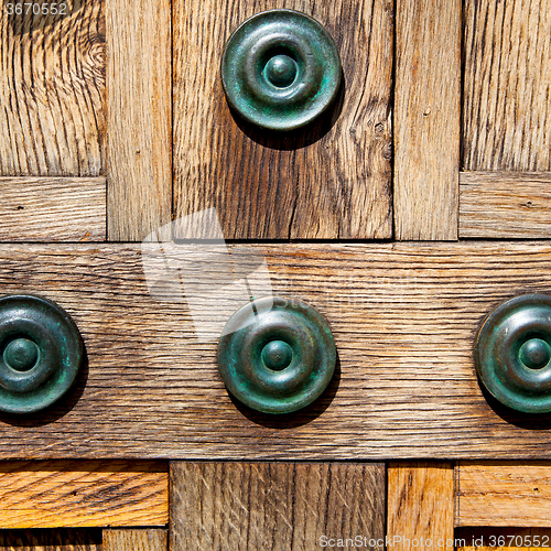 Image of in london antique brown door  rusty  brass nail and light