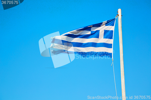 Image of waving in the blue sky and flagpole