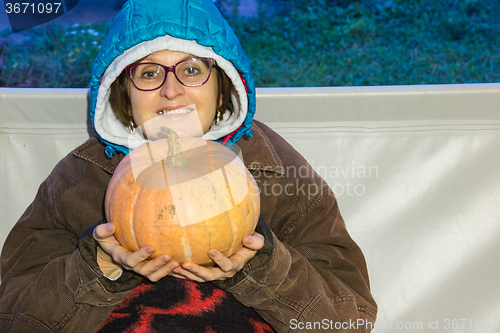 Image of A woman with a pumpkin  