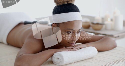 Image of Woman Getting Hot Stones Massage At Spa
