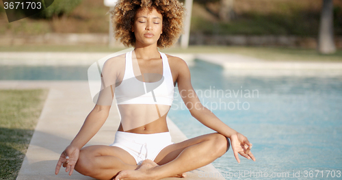 Image of Healthy Woman Meditating Near The Pool