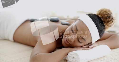 Image of Woman Getting Hot Stones Massage At Spa