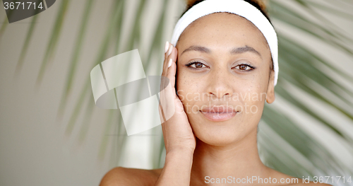 Image of Woman With Makeup Touching Her Face