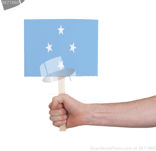 Image of Hand holding small card - Flag of Micronesia