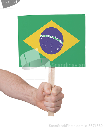 Image of Hand holding small card - Flag of Brazil