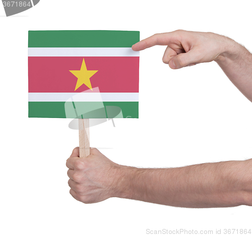 Image of Hand holding small card - Flag of Suriname