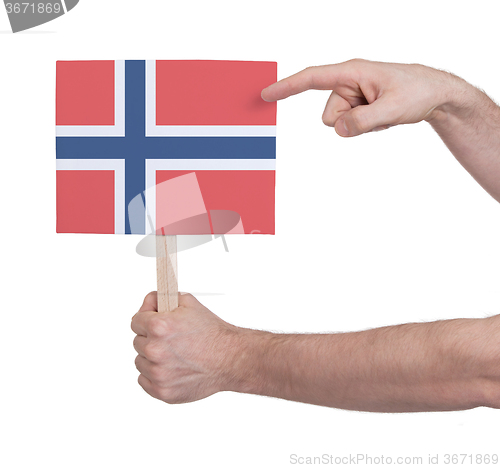 Image of Hand holding small card - Flag of Norway