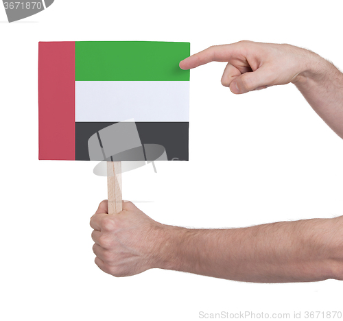 Image of Hand holding small card - Flag of Sudan