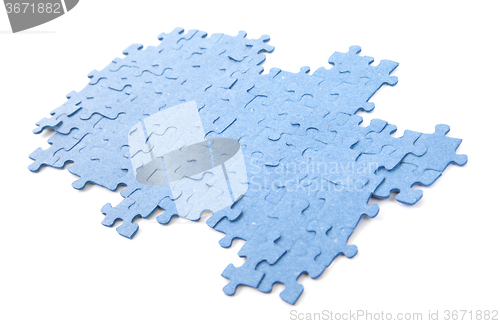 Image of Connected blue puzzle pieces isolated