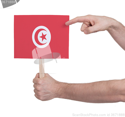 Image of Hand holding small card - Flag of Tunisia