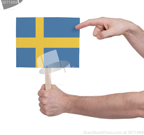 Image of Hand holding small card - Flag of Sweden