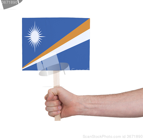 Image of Hand holding small card - Flag of Marshall Islands