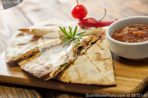 Image of Tacos on wooden background with sauce