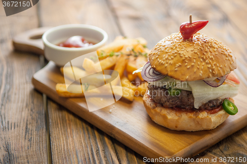 Image of Home made burgers on wooden background