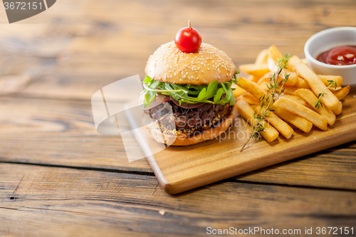 Image of Home made burgers on wooden background
