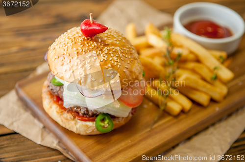 Image of Home made burgers on wooden background