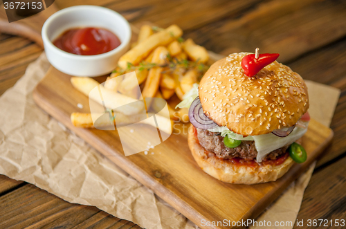 Image of Home made burgers on wooden background