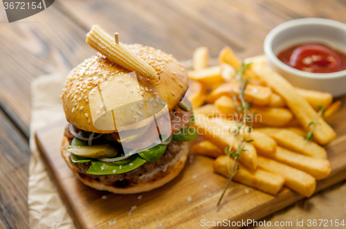 Image of Home made burgers on wooden background