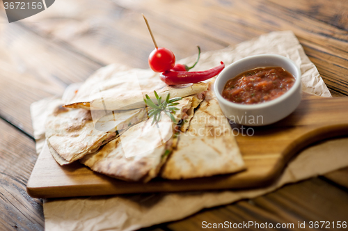 Image of Tacos on wooden background with sauce