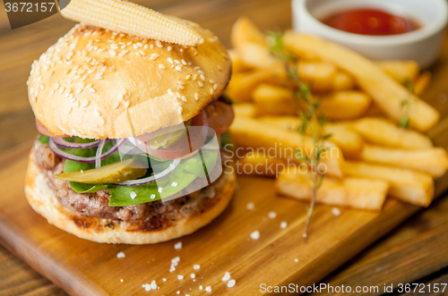 Image of Home made burgers on wooden background