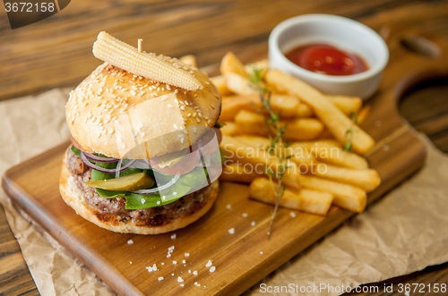 Image of Home made burgers on wooden background