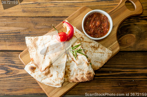 Image of Tacos on wooden background with sauce