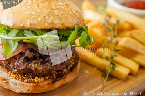 Image of Home made burgers on wooden background