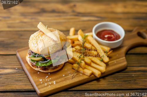 Image of Home made burgers on wooden background