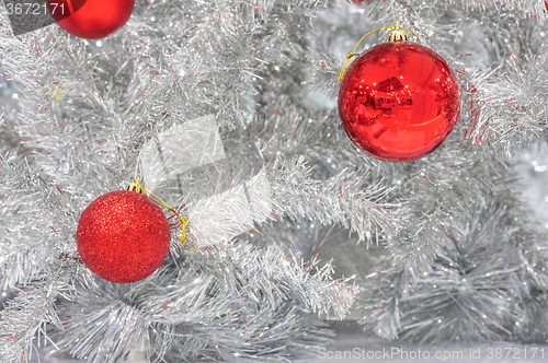 Image of Red baubles on silver artificial christmas tree