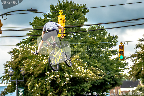 Image of bmx extreme team making stunt in downtown york south carolina at