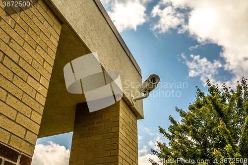 Image of Three security cameras attached on the office building corner