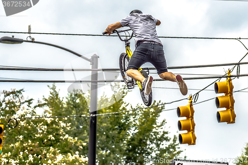 Image of bmx extreme team making stunt in downtown york south carolina at