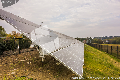 Image of green energy solar panels on a cloudy day