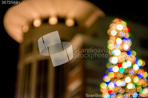 Image of defocused christmas tree lights in a city background