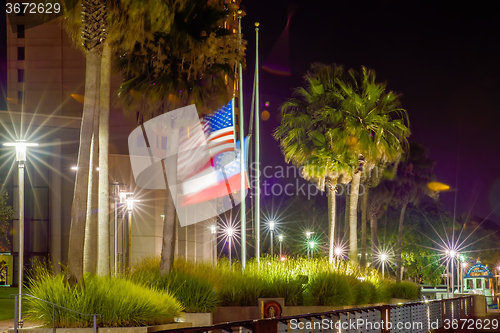 Image of usa flag waving in the wind near river in savannah georgia at ni