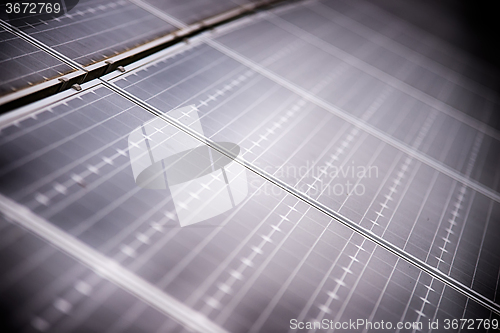 Image of green energy solar panels on a cloudy day