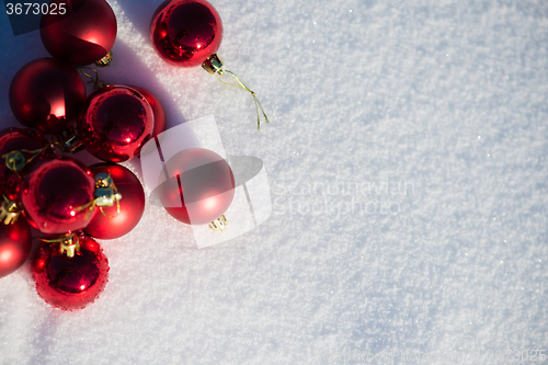 Image of red christmas ball in fresh snow