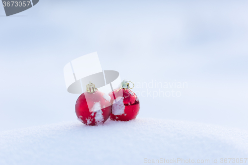 Image of red christmas balls in fresh snow