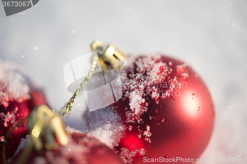 Image of red christmas ball in fresh snow