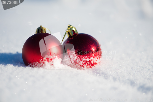 Image of red christmas ball in fresh snow