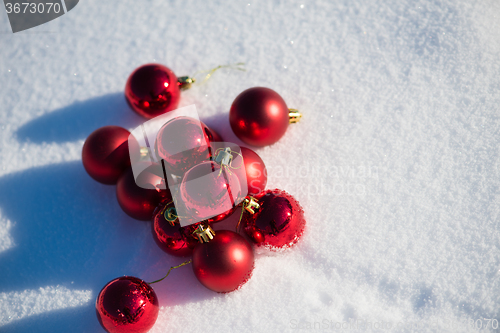 Image of red christmas ball in fresh snow